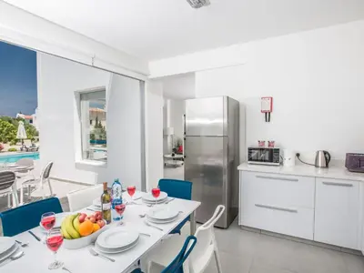 a kitchen and dining room with a table and chairs at Holiday Home Protaras Greco Villa CCV2 by Interhome in Protaras
