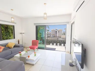 a living room with a couch and a red chair at Holiday Home Ferienvilla für 10 Personen in Protaras by Interhome in Protaras