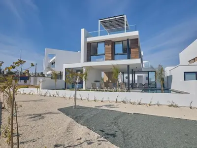 a large white house on a beach at Holiday Home Protaras Aqua Pearl Villa AQ12 by Interhome in Protaras