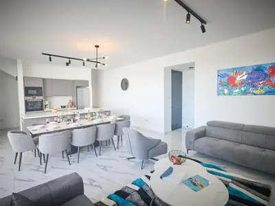 a living room with a table and chairs and a couch at Holiday Home Protaras Aqua Pearl Villa AQ12 by Interhome in Protaras