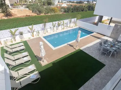 an overhead view of a swimming pool with chairs and a table at Holiday Home Protaras Aqua Pearl Villa AQ05 by Interhome in Protaras