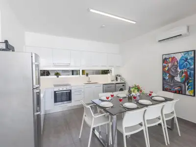 a kitchen with a table and chairs and a refrigerator at Holiday Home Greco Villa CCV4- 5-Schlafzimmer-Villa mit privatem Pool in Protaras Zentrum by Interhome in Protaras