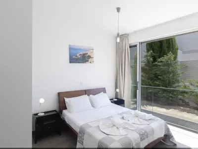 a bedroom with a bed and a large window at Holiday Home Greco Villa CCV4- 5-Schlafzimmer-Villa mit privatem Pool in Protaras Zentrum by Interhome in Protaras