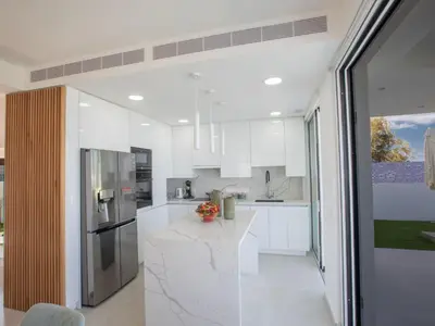 a kitchen with white cabinets and a counter top at Holiday Home Eleganter Urlaub Artizan Villa AR5 by Interhome in Protaras