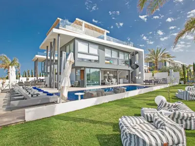 a villa with a swimming pool and lawn at Holiday Home Haus in Paralimni mit großem Patio by Interhome in Paralimni