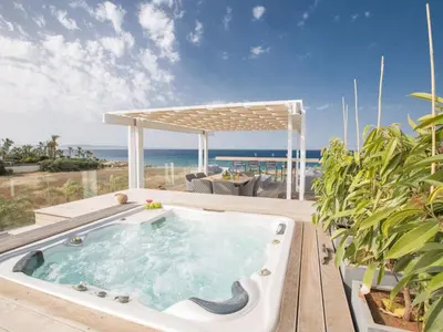 a hot tub on a deck with the ocean in the background at Holiday Home Haus in Paralimni mit großem Patio by Interhome in Paralimni