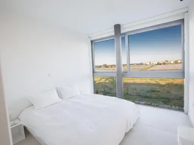 a bedroom with a white bed and a large window at Holiday Home Neue- moderne 3-Schlafzimmer-Villa mit privatem Pool by Interhome in Paralimni