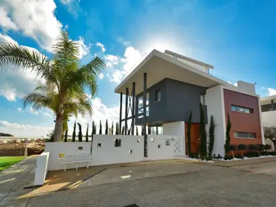 a house with a palm tree in front of it at Holiday Home Protaras Ferienvilla mit privatem Pool- Whirlpool by Interhome in Paralimni