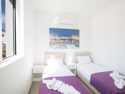 two beds in a room with a window at Holiday Home Protaras - schönes Ferienhaus für 10 Personen by Interhome in Protaras