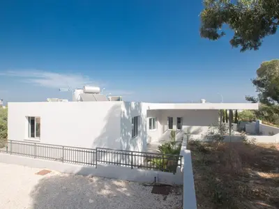 a white house with a fence in front of it at Holiday Home Protaras - schönes Ferienhaus für 10 Personen by Interhome in Protaras