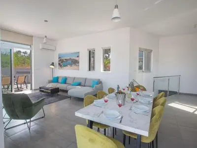 a dining room and living room with a table and chairs at Holiday Home Protaras - schönes Ferienhaus für 10 Personen by Interhome in Protaras