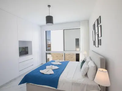 a white bedroom with a large bed with towels on it at Holiday Home Protaras Vie Bleu Villa VB5 by Interhome in Protaras