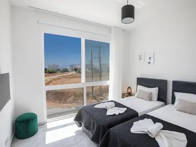 two beds in a room with a large window at Holiday Home Protaras Vie Bleu Villa VB5 by Interhome in Protaras