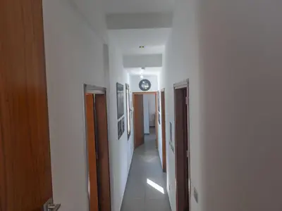 a hallway with a clock on the ceiling and a clock on the wall at Holiday Home Ayia Napa Satin Villa SVI1 by Interhome in Ayia Napa