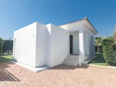 a white house with a staircase in a yard at Holiday Home Ayia Napa Satin Villa SVI1 by Interhome in Ayia Napa