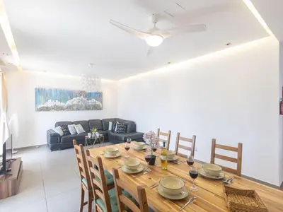 a dining room with a table and a couch at Holiday Home Ayia Napa Satin Villa SVI1 by Interhome in Ayia Napa