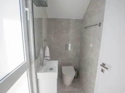 a small bathroom with a toilet and a shower at Holiday Home 4-Schlafzimmer-Villa mit Pool im Zentrum von Protaras by Interhome in Protaras