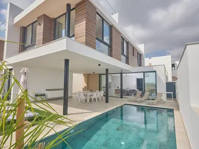 a house with a swimming pool in front of a house at Holiday Home Protaras Aqua Pearl Villa AQ11 im Zentrum by Interhome in Protaras