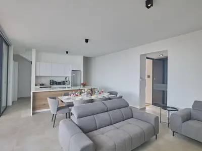 a living room with a couch and a table at Holiday Home Protaras Aqua Pearl Villa AQ11 im Zentrum by Interhome in Protaras