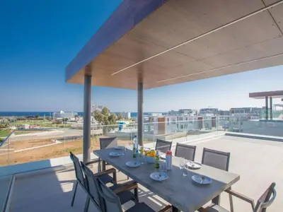 a dining table on the balcony of a house at Holiday Home Schöne Villa Olivine Pearl OL5 mit Garten by Interhome in Protaras