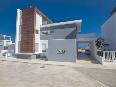 a large white building with a brick pillar at Holiday Home Schöne Villa Olivine Pearl OL5 mit Garten by Interhome in Protaras