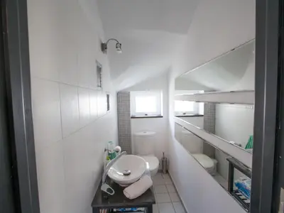 a small white bathroom with a sink and a toilet at Holiday Home Charmante 3-Schlafzimmer-Villa DI12 mit privatem Pool by Interhome in Protaras