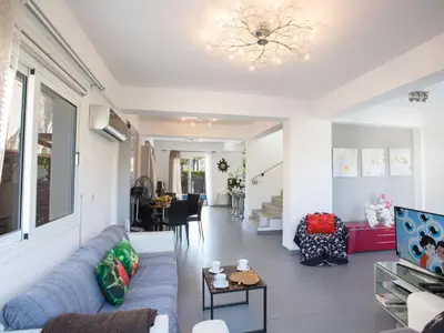 a living room with a couch and a chandelier at Holiday Home Charmante 3-Schlafzimmer-Villa DI12 mit privatem Pool by Interhome in Protaras