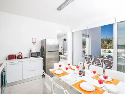 a kitchen and dining room with a table and chairs at Holiday Home Neue Ferienvilla für 10 Personen by Interhome in Protaras