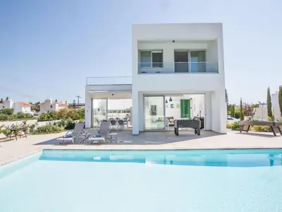 a villa with a swimming pool in front of a house at Holiday Home Neue Ferienvilla für 10 Personen by Interhome in Protaras