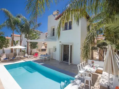 a villa with a swimming pool and a house at Holiday Home 3-Schlafzimmer-Luxusvilla mit Pool und teilweise Meerblick by Interhome in Protaras