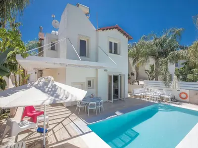 a villa with a swimming pool and a house at Holiday Home 3-Schlafzimmer-Luxusvilla mit Pool und teilweise Meerblick by Interhome in Protaras