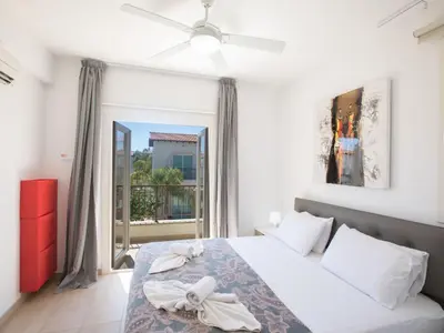 a bedroom with a bed and a large window at Holiday Home 3-Schlafzimmer-Luxusvilla mit Pool und teilweise Meerblick by Interhome in Protaras