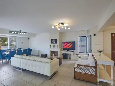 a living room with a couch and a tv in it at Holiday Home Protaras Serifos Villa SV7 100m vom Strand entfernt by Interhome in Paralimni
