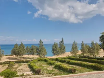 a view of a beach with trees and the ocean at Holiday Home Protaras Serifos Villa SV7 100m vom Strand entfernt by Interhome in Paralimni