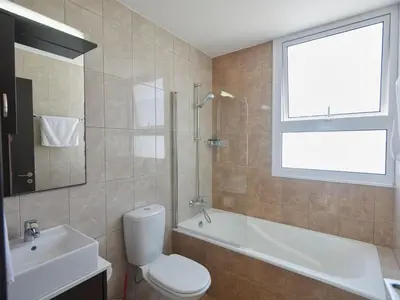 a bathroom with a toilet and a tub and a sink at Holiday Home in Paralimni mit geräumigem Garten by Interhome in Paralimni