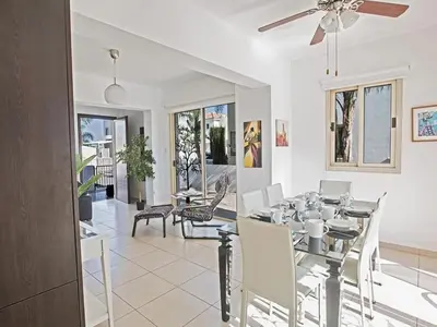 a dining room with a table and chairs at Holiday Home Ferienvilla PV17 mit Sonnenterrasse und Pool by Interhome in Protaras