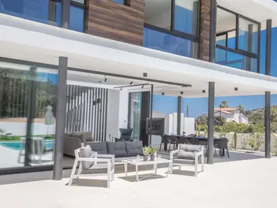 an open living room and dining area of a house at Holiday Home Geräumige Villa mit großem Garten und Pool by Interhome in Protaras