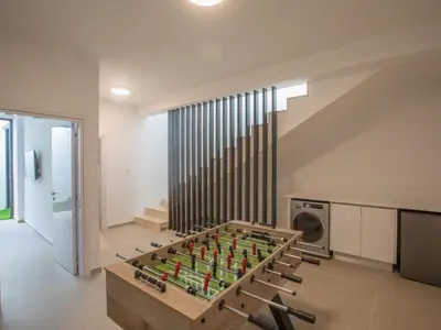 a large wooden foosball table in a living room at Holiday Home Geräumige Villa mit großem Garten und Pool by Interhome in Protaras