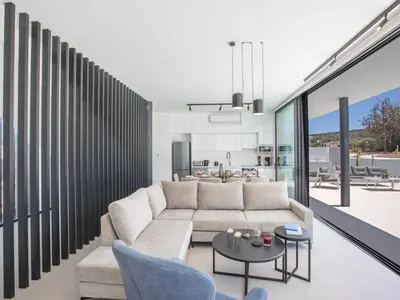a living room with a couch and a table at Holiday Home in Protaras mit großem Garten by Interhome in Protaras