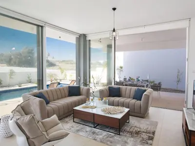 a living room with two couches and a table at Holiday Home 3-Schlafzimmer-Villa mit privatem Pool im Zentrum by Interhome in Protaras