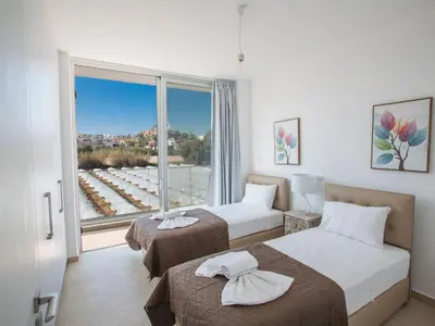 a hotel room with two beds and a large window at Holiday Home 3-Schlafzimmer-Villa mit privatem Pool im Zentrum by Interhome in Protaras