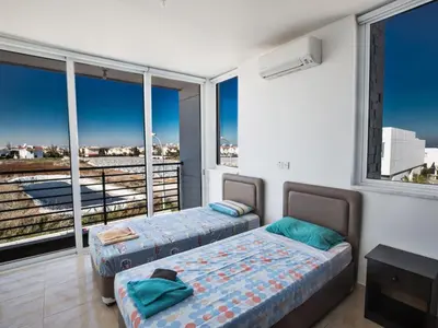 two beds in a room with a large window at Holiday Home Protaras Perle Villa PE16 by Interhome in Protaras