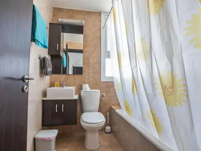 a bathroom with a toilet and a sink and a mirror at Holiday Home Protaras Perle Villa PE16 by Interhome in Protaras