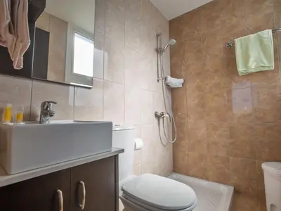 a bathroom with a white toilet and a sink at Holiday Home Protaras Perle Villa PE16 by Interhome in Protaras