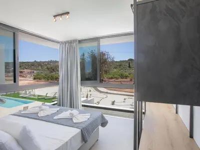 a bedroom with a bed and a large window at Holiday Home mit Privatpool für 11 Personen ca- 220 m² in Protaras- Südküste von Zypern by Interhome in Protaras