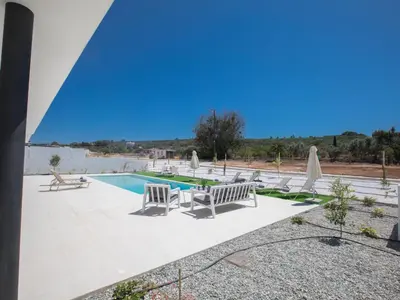 a swimming pool with lounge chairs and a swimming pool at Holiday Home mit Privatpool für 11 Personen ca- 220 m² in Protaras- Südküste von Zypern by Interhome in Protaras