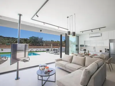 a living room with a couch and a tv at Holiday Home mit Privatpool für 11 Personen ca- 220 m² in Protaras- Südküste von Zypern by Interhome in Protaras