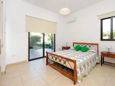a bedroom with a bed and a large window at Holiday Home Protaras Ferienvilla AV6 by Interhome in Protaras