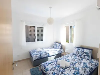 a room with two beds and two windows at Holiday Home Protaras Blauer Fluss Villa BR26 by Interhome in Protaras