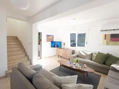 a living room with a couch and a table at Holiday Home Protaras Blauer Fluss Villa BR26 by Interhome in Protaras